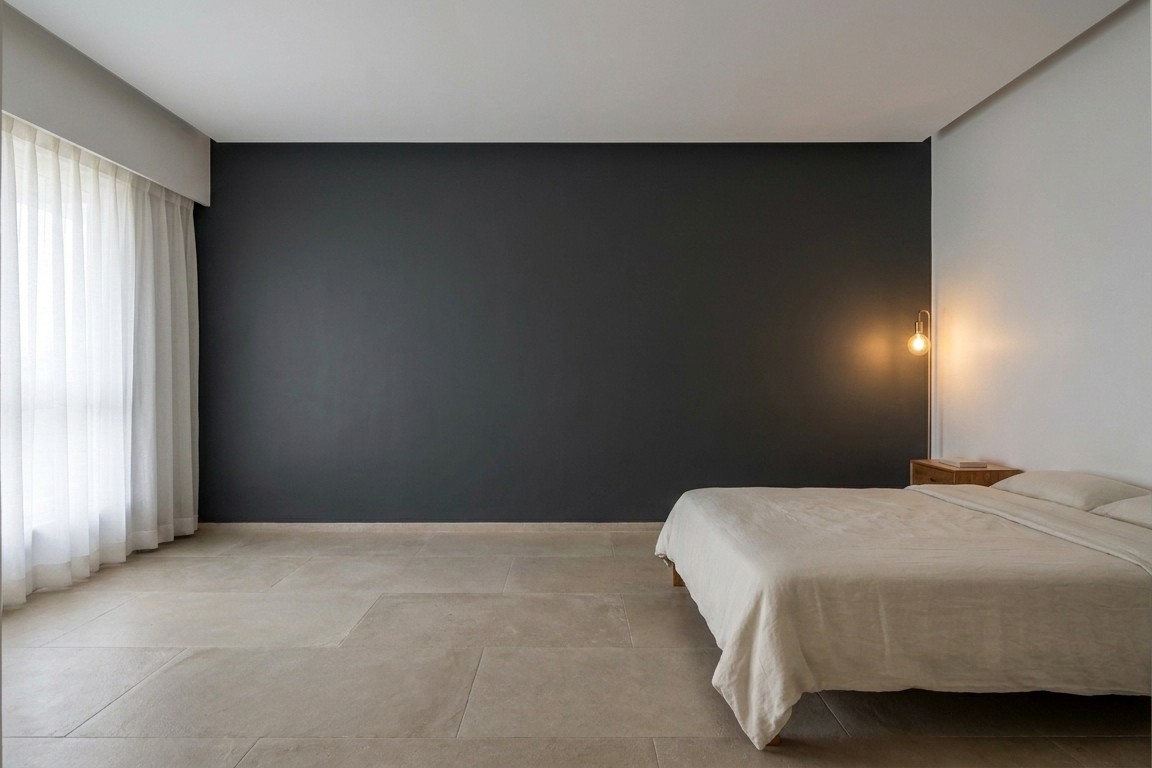 Bedroom with dark far wall creating depth, lighter walls near the entrance.