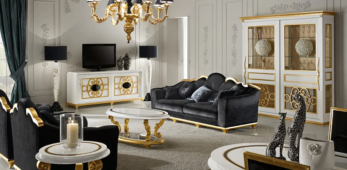 Black-and-gold baroque living set: black velvet sofa and armchairs with gilded scrollwork frames, a white lacquer TV sideboard with gold filigree doors