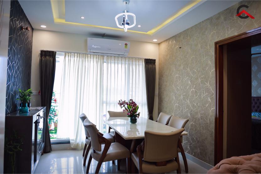 Dining room with a textured branch-pattern wallpaper, a geometric pendant over a marble-top table, and a dark textured stone accent wall by the console.
