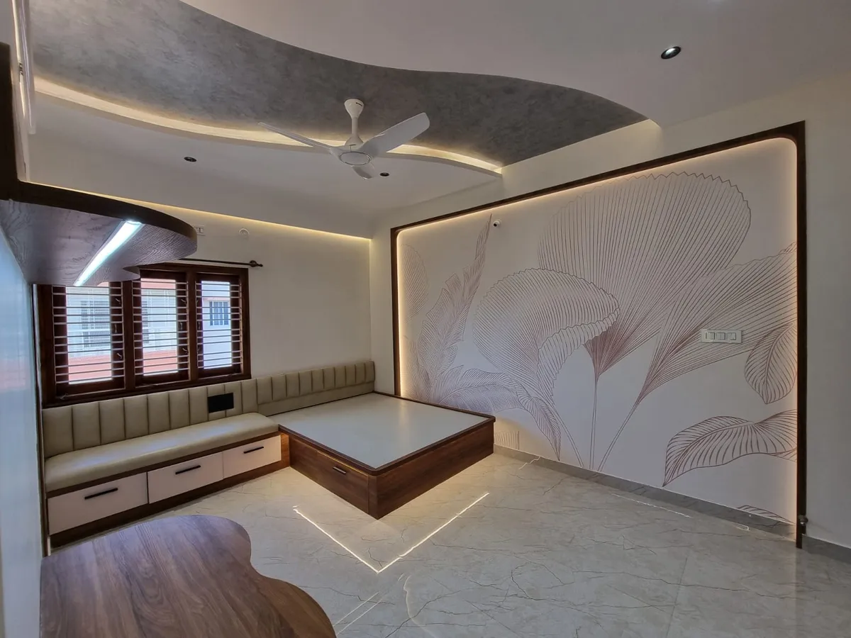 Bedroom with a wood platform bed lit by an under-base LED profile, a botanical line-art wallpaper mural and a built-in tufted window seat.