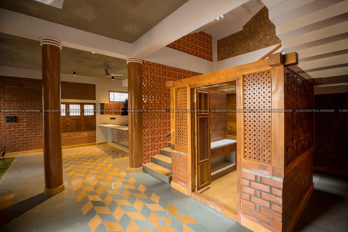 Elevated wooden pooja room enclosure with carved jaali lattice screens and a brick base, reached by steps