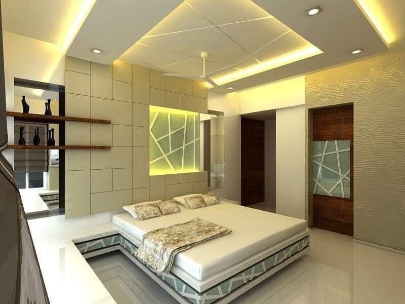 Render of a bedroom with a raised platform bed on a fractured-glass-pattern base, a tufted feature wall behind, and a multi-tier cove-lit false ceiling.