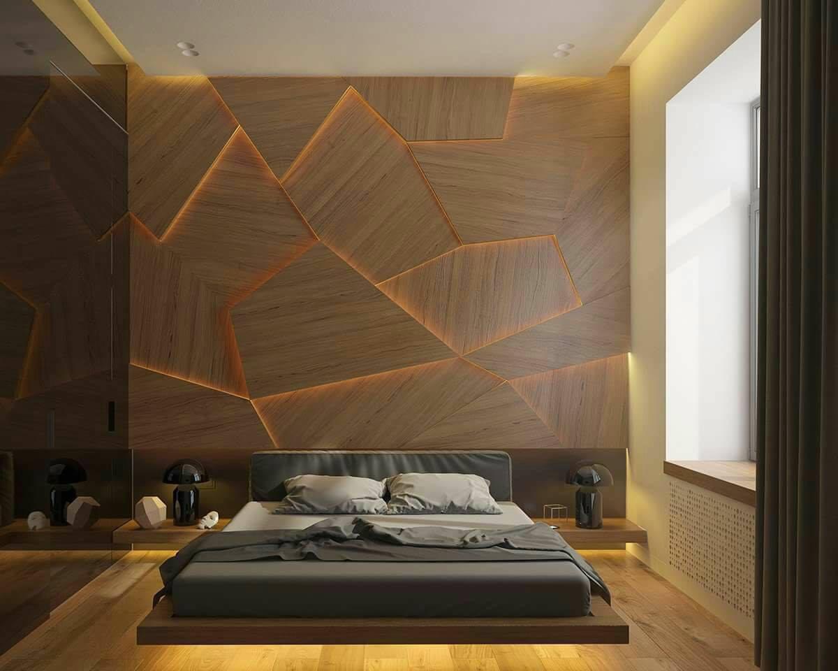 Render of a master bedroom with a dramatic faceted wood panel headboard wall lit by warm LED strip inlays, a low floating platform bed