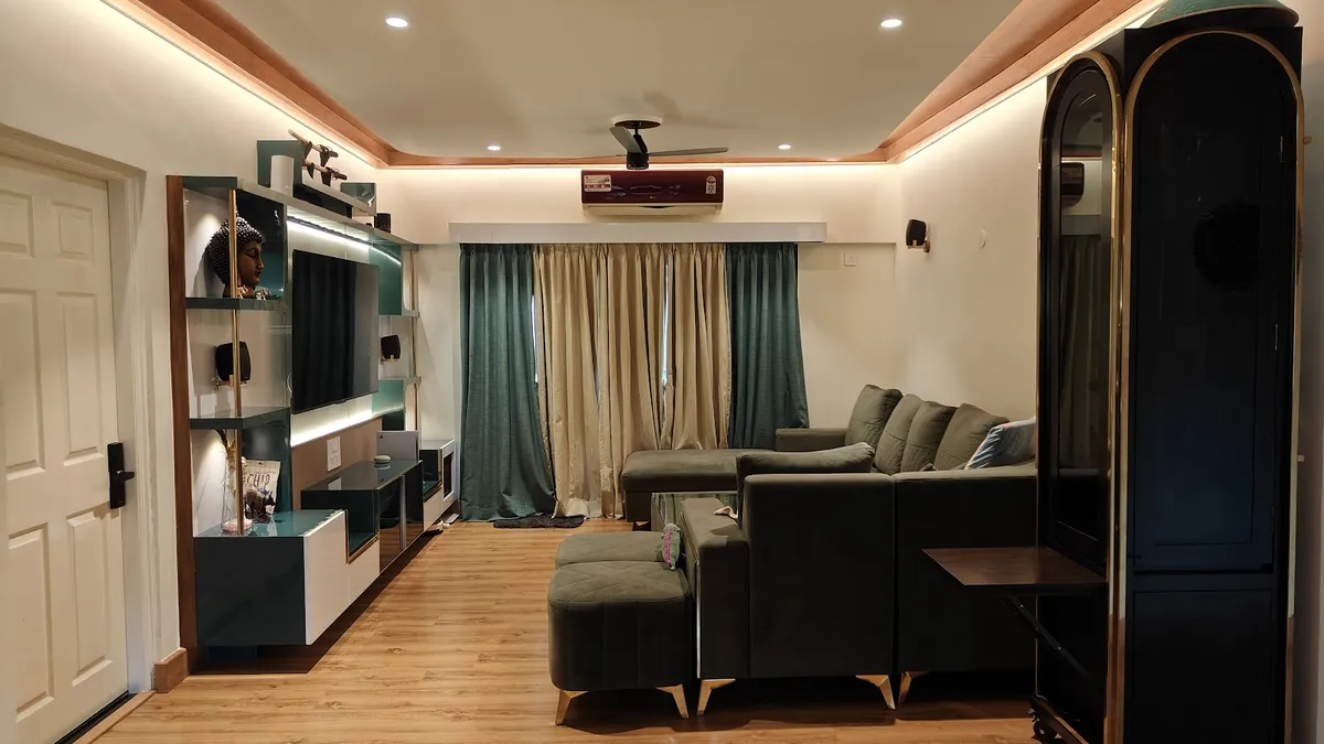 Teal-and-white TV unit with backlit glass shelving faces an olive velvet sectional