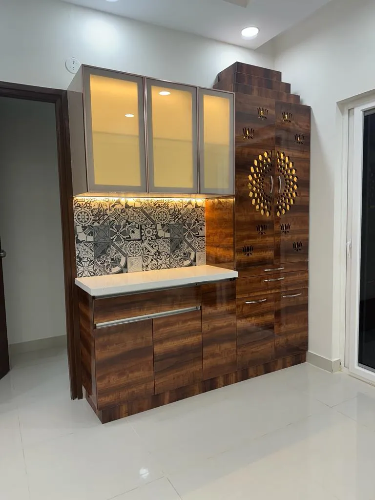 Walnut-laminate crockery unit with aluminium-framed frosted glass wall cabinets over a black-and-white patterned dado and white counter