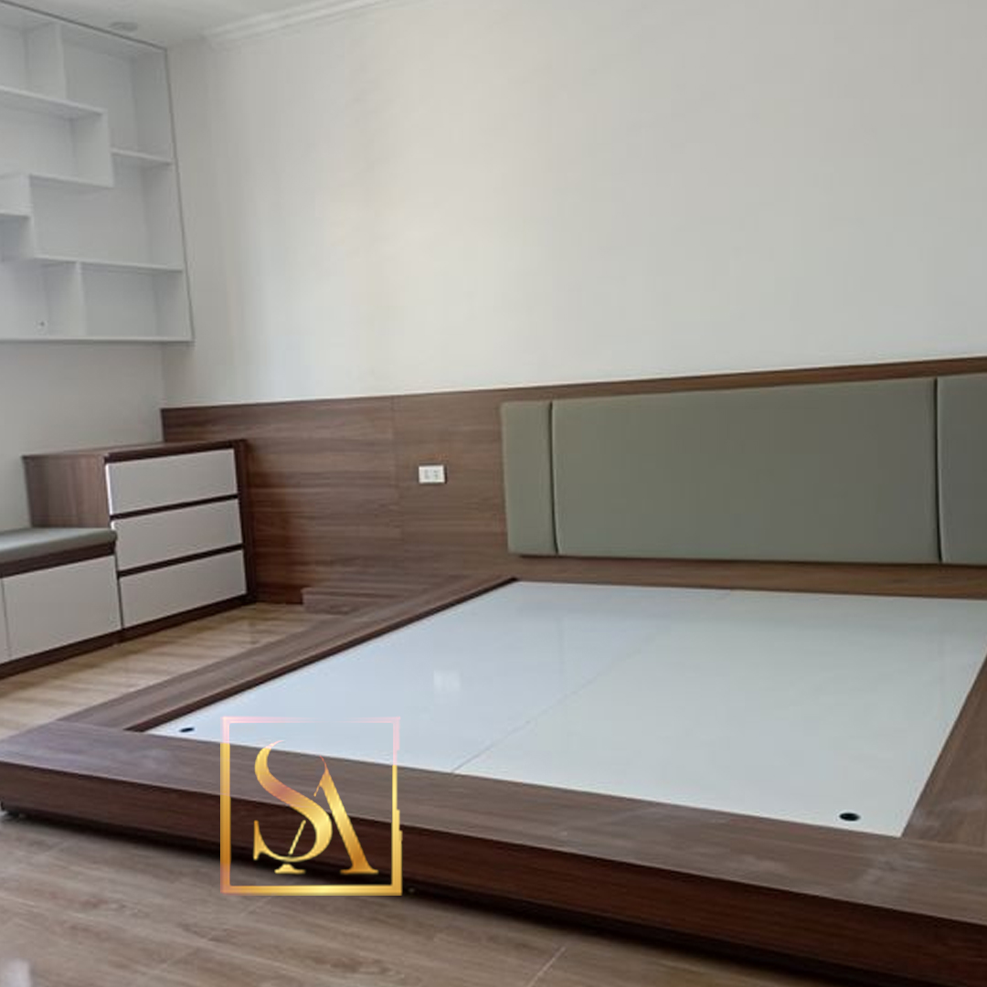 Master bedroom with a built-in low platform bed featuring a sage-green channel-tufted headboard against a wood-panelled wall