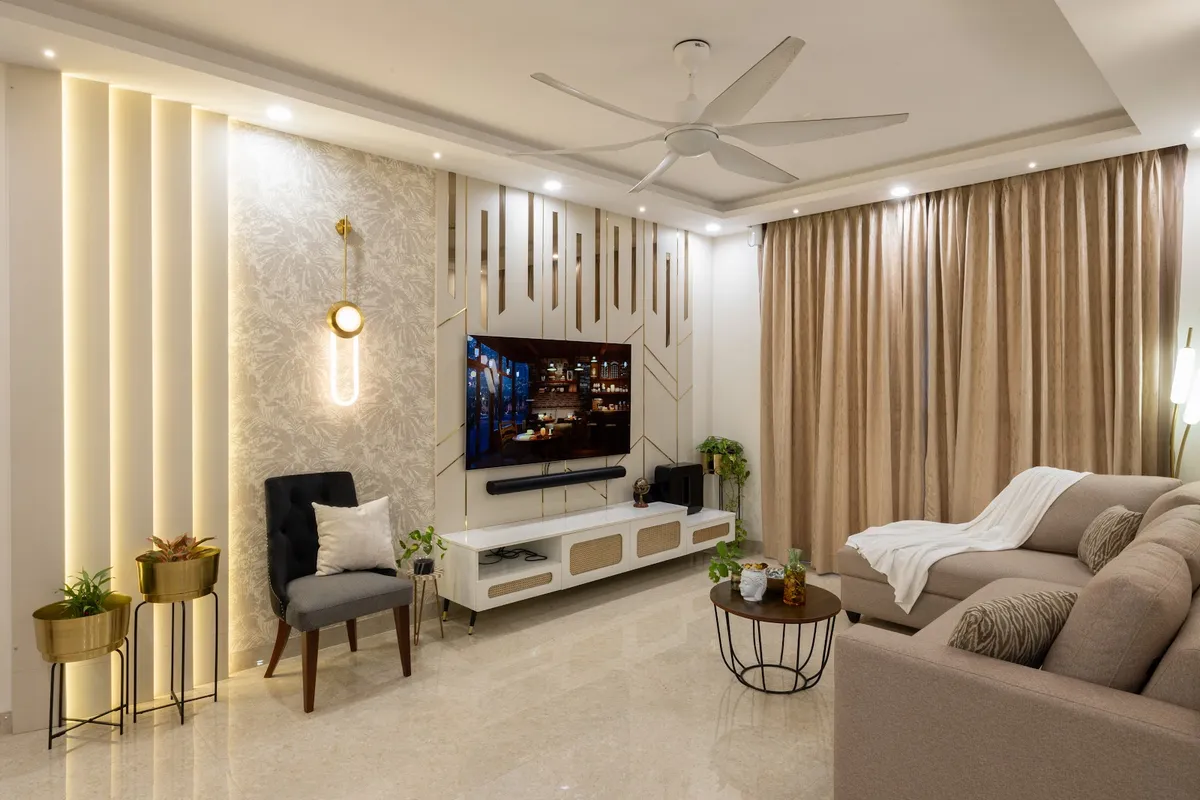Living room with a backlit fluted wall panel and floral wallpaper accent, a brass-trimmed TV console with rattan fronts