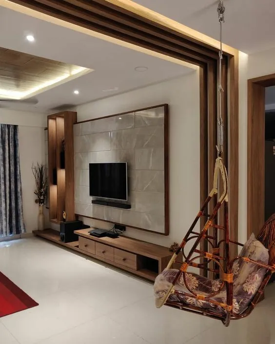 Living room TV feature wall framed in wood battens around a marble-look tile panel