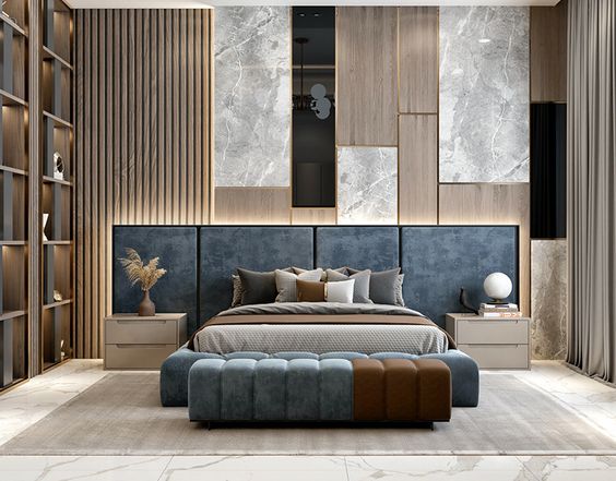 Render of a master bedroom with a slate-blue upholstered headboard wall, marble-and-wood panelling and a two-tone tufted bench