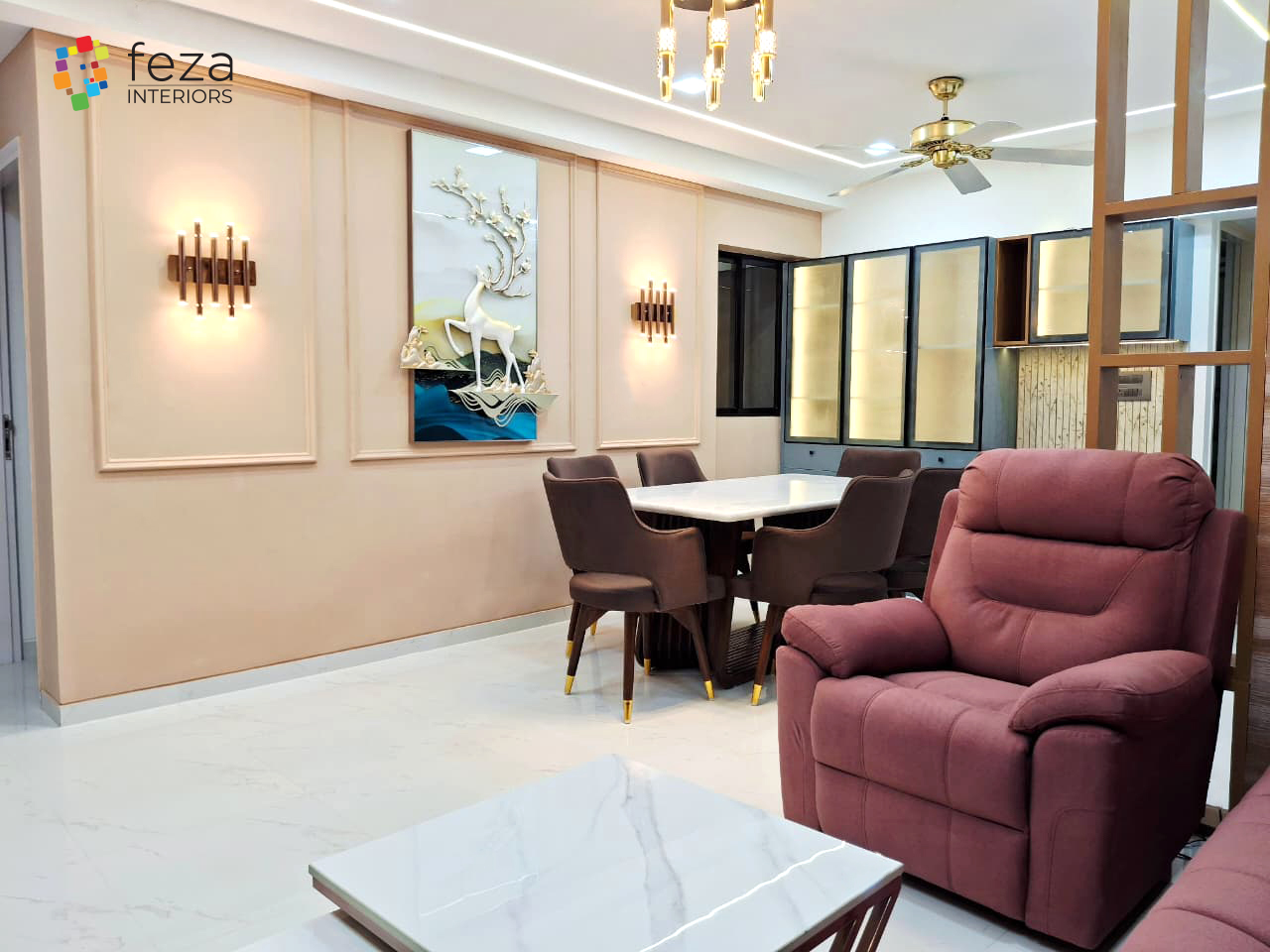 Open-plan dining and living area with a peach panel-moulding wall featuring a 3D deer wall art piece, a marble-top dining table