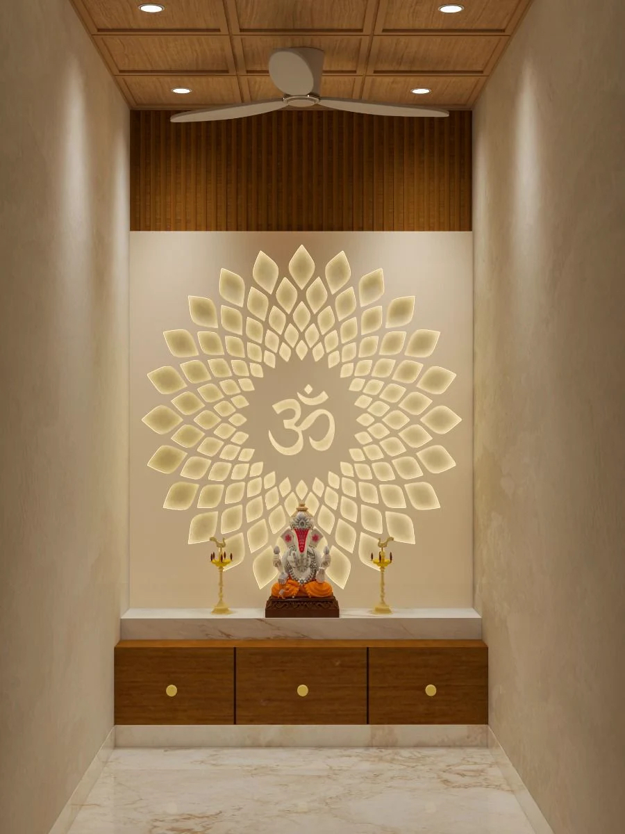 Render of a pooja room niche with a backlit CNC-cut lotus-and-Om wall panel above a marble-topped wood cabinet holding a Ganesh idol, under a wood-slat ceiling.