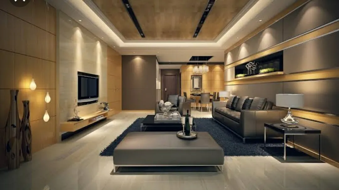 Render of an open living room with a backlit wood-panel TV wall, leather sofa and ottoman on a dark rug, dining table visible beyond.