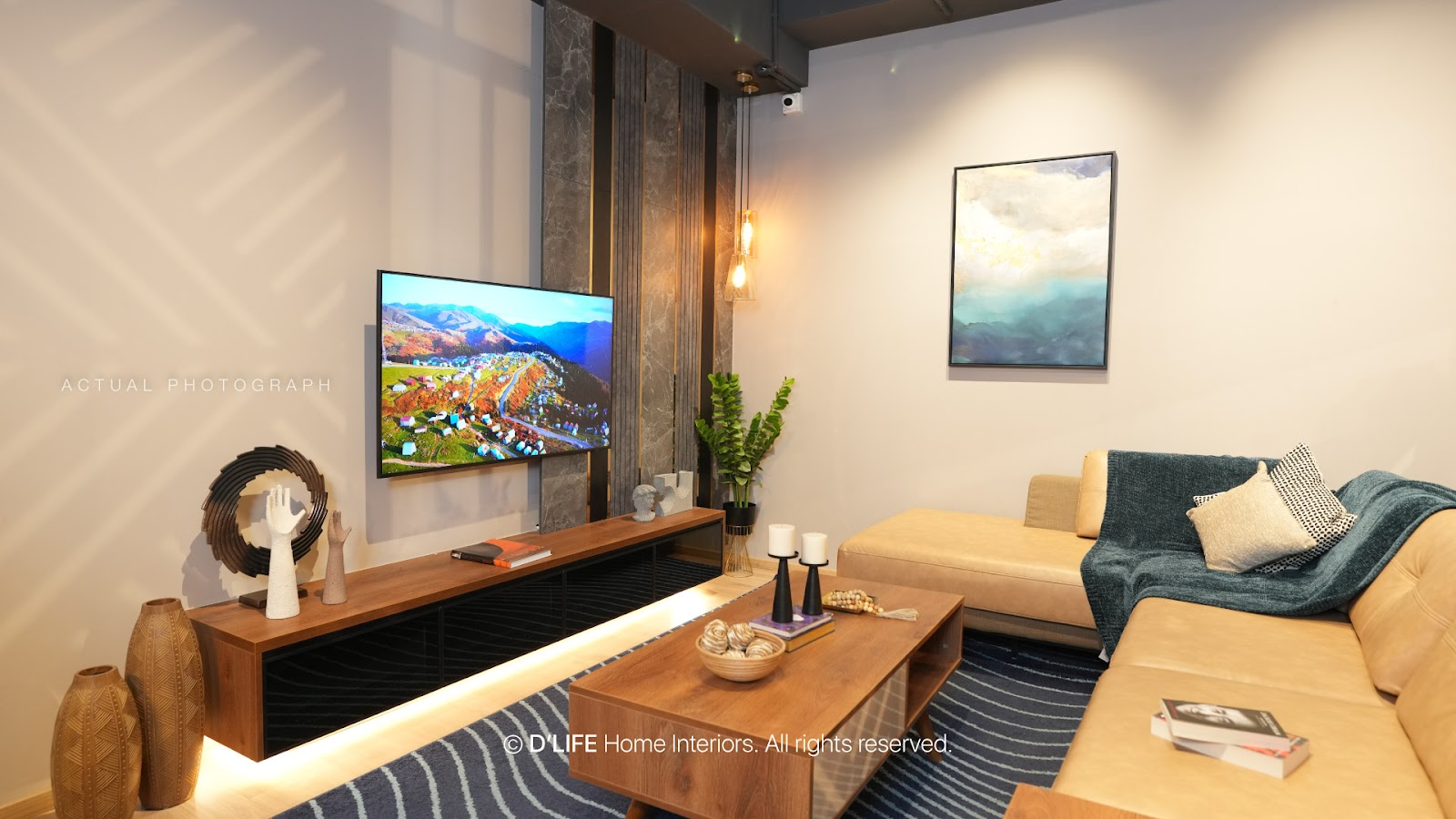 Living room with a floating wood TV console lit by an LED strip against a dark stone-panel accent wall, a tan leather sectional sofa with a teal throw