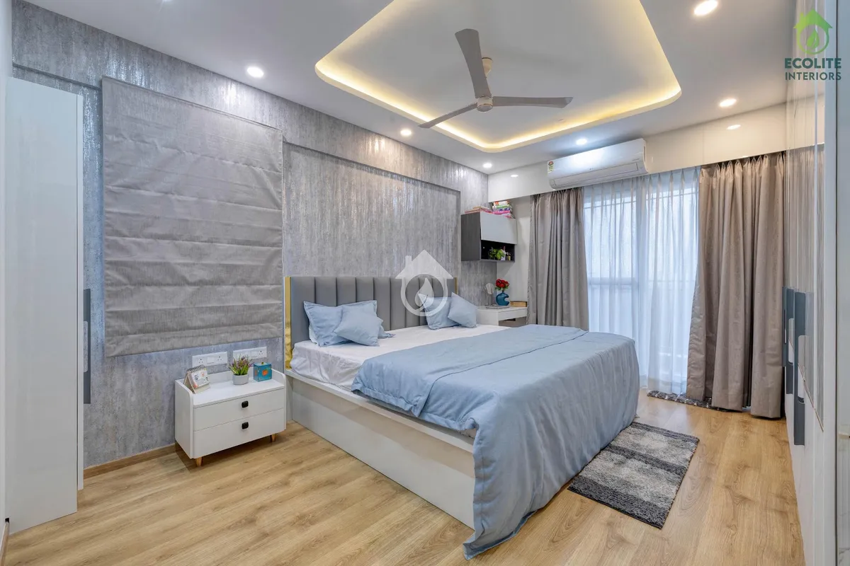 Bedroom with a mottled silver-grey textured back wall and matching grey roman blind