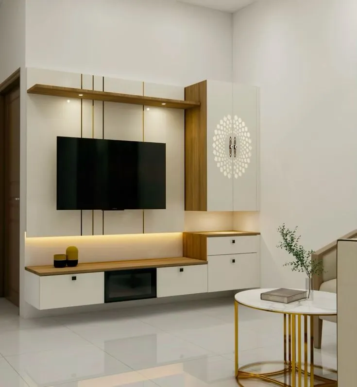 Render — a floating TV unit in white and wood with slim brass inlay lines and backlit cove lighting, beside a gold-framed marble side table.