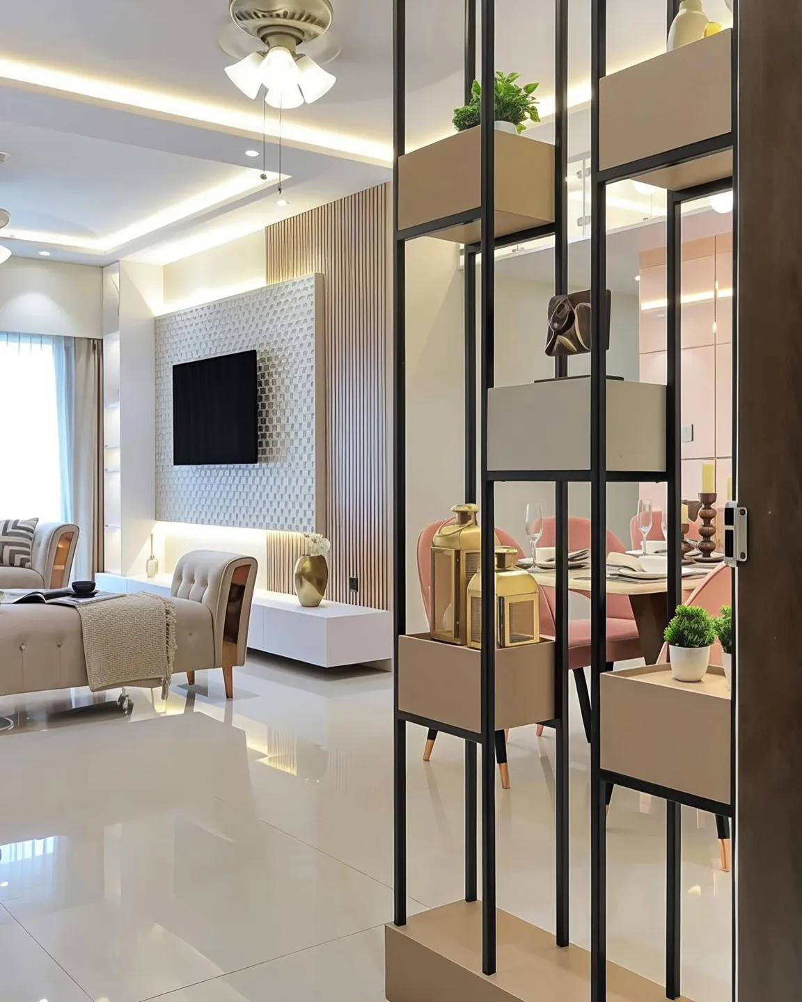 Open-plan living and dining separated by a black metal box-shelf partition, with a fluted TV feature wall on one side and pink dining chairs glimpsed through it