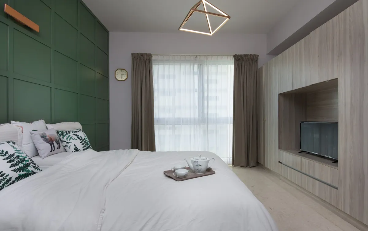 Bedroom with a forest-green grid-panelled headboard wall under a copper linear reading light, a geometric copper-frame pendant over the bed