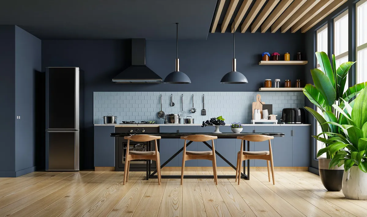 Render of a navy single-wall kitchen — slate-blue matte base units under a black worktop and pale blue metro dado with a hanging utensil rail
