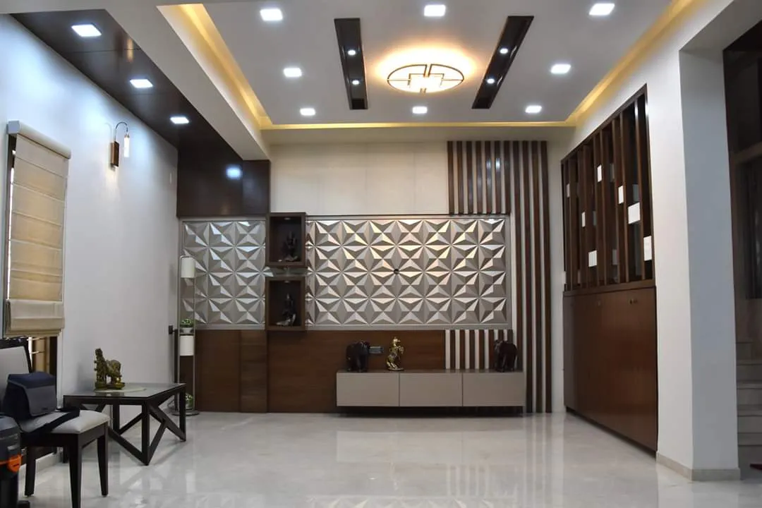 Living room with a 3D geometric feature wall flanked by display niches holding brass idols, a wood-slat partition screen, a wood console below