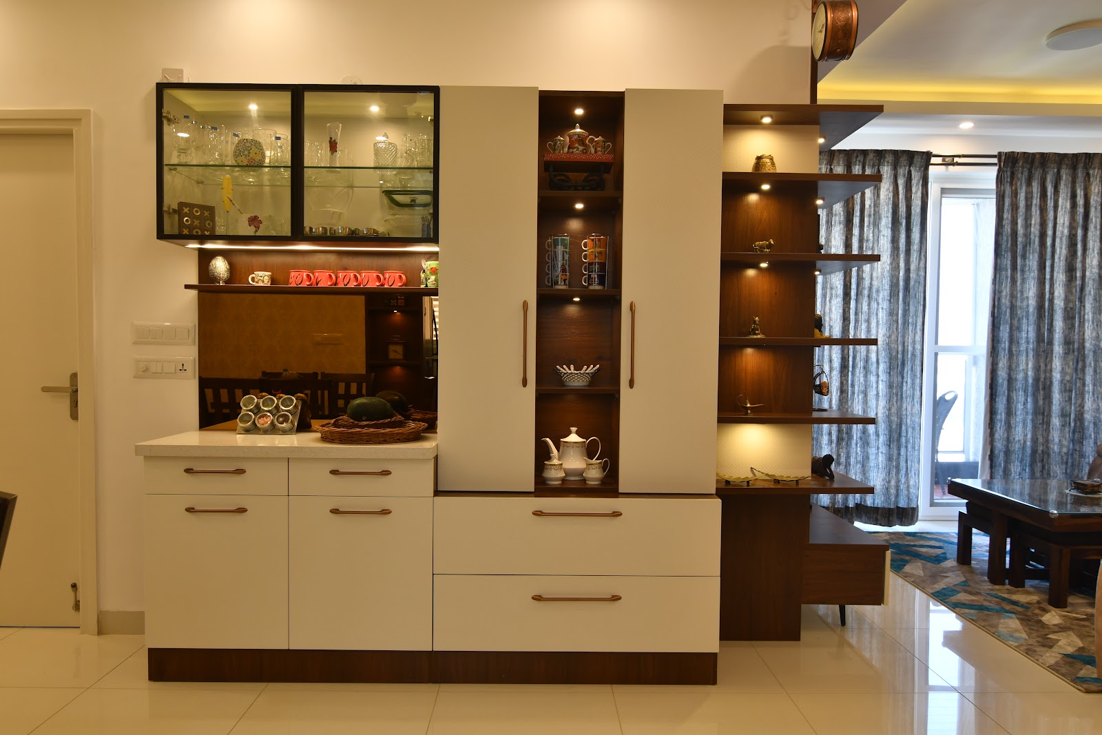 Dining room crockery unit with glass-front upper cabinets, backlit open display shelving and white lacquer drawers