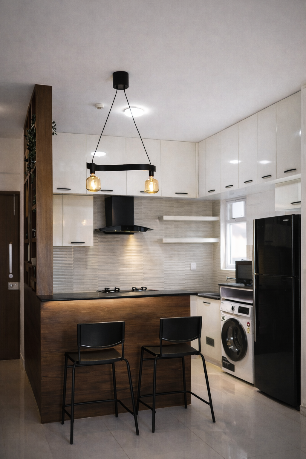 Kitchen with a black chimney hood over a black-countertop island, wood-panel island front, dual pendant lighting