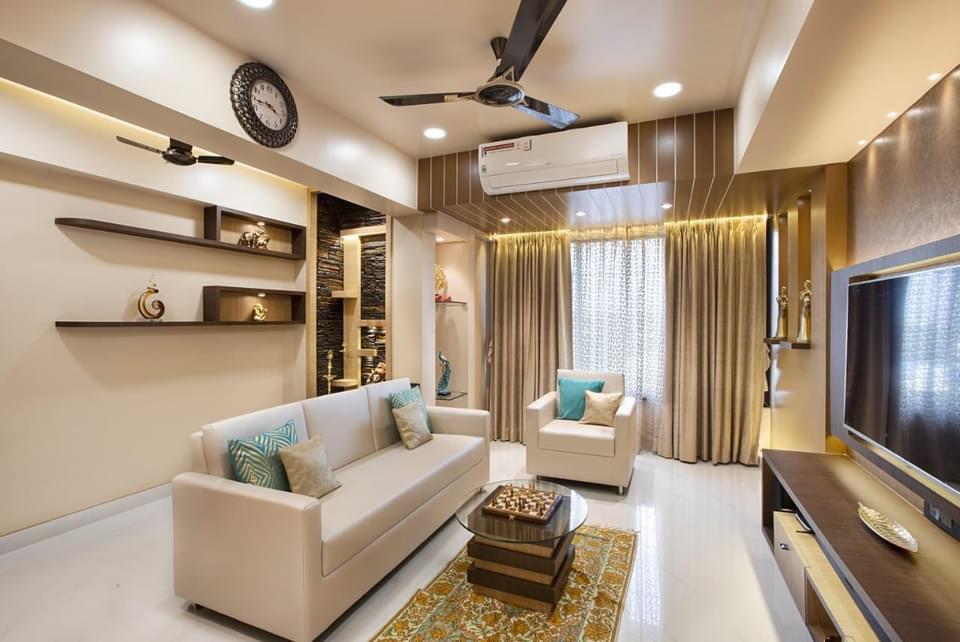 Living room with a wood-slat cove ceiling, a dark stone-textured display niche wall, floating wooden shelves styled with curios
