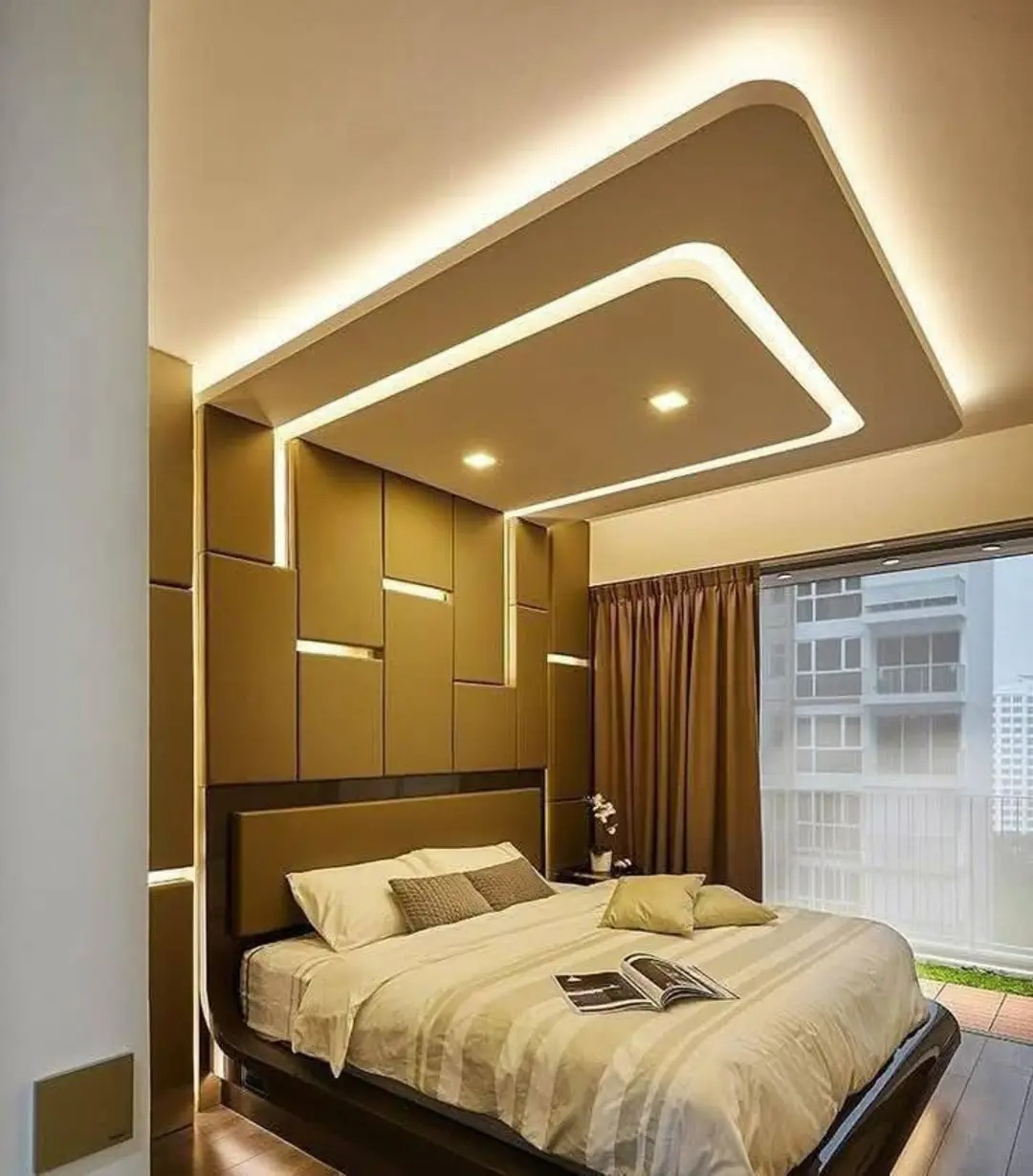 Render of a bedroom with a gold 3D-panelled accent wall that wraps into a cove-lit box ceiling above the bed, and floor-to-ceiling city-view windows.