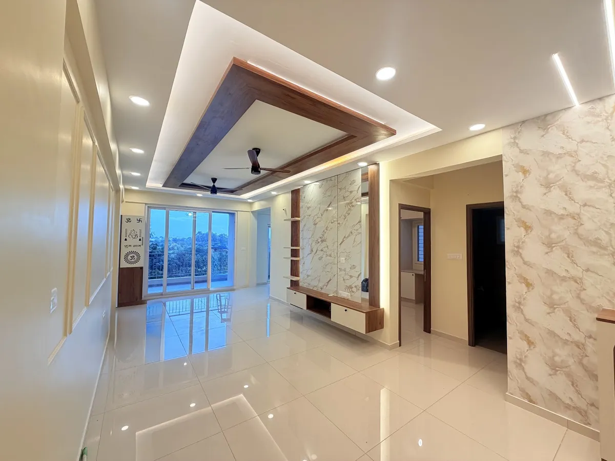 Empty flat living room with a mitred wood-framed dropped POP ceiling carrying two fans