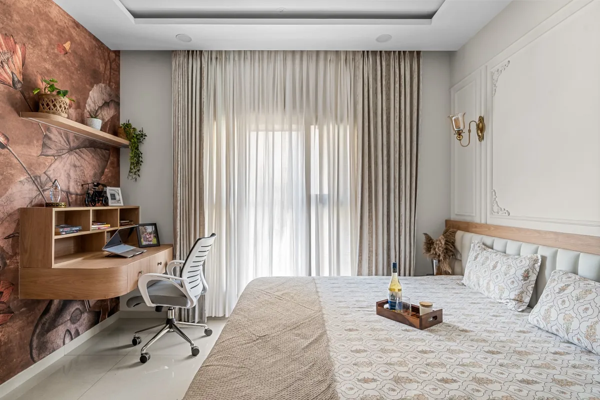 Bedroom with a terracotta botanical mural wall behind a built-in floating study desk, sheer and heavy drapes at the window