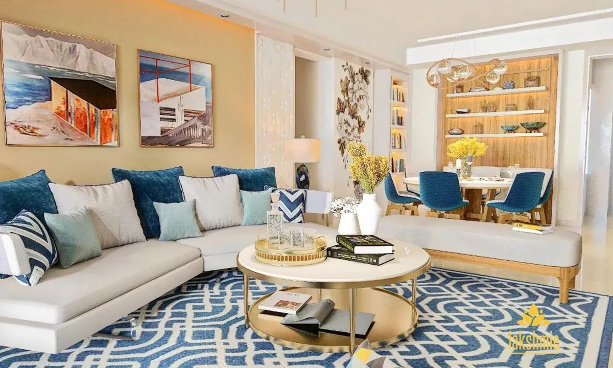 Render of an open living room with a white L-sofa piled with teal and indigo cushions over a blue maze-pattern rug, a two-tier brass coffee table