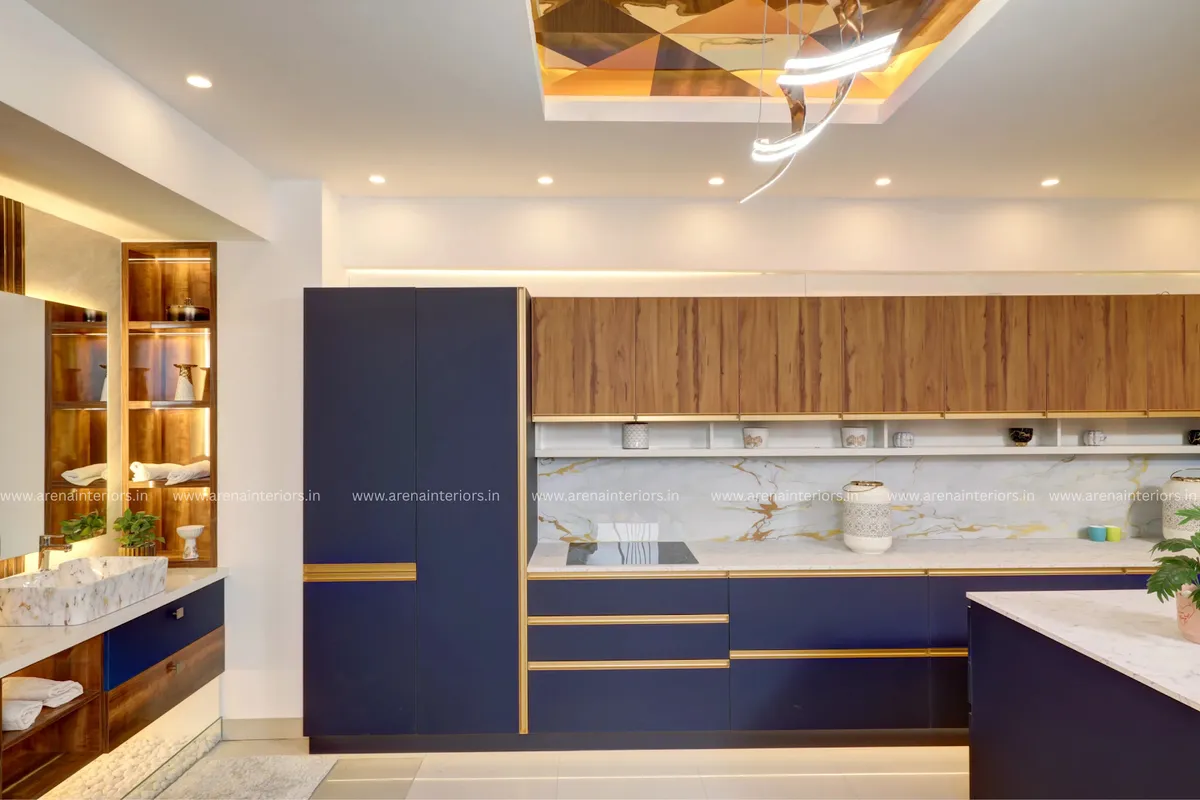 Kitchen with navy-blue and gold-trim cabinetry, a wood-panel upper unit, gold-veined marble backsplash and island counter