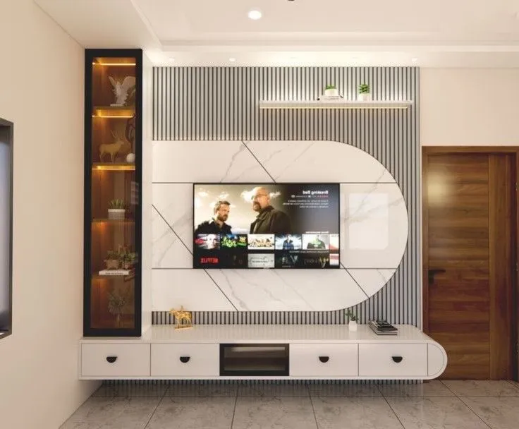 A living room TV feature wall with a marble-clad capsule panel set into fluted wall panelling, a floating white TV console