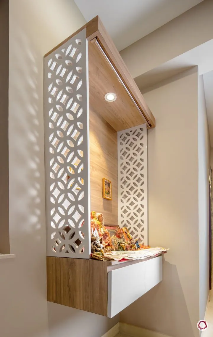 Wall-hung pooja unit in a corner - a wood-laminate back panel and hood with a single warm spot in the canopy