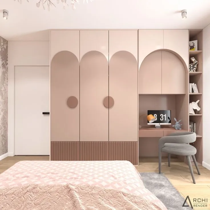 Render of a girl's bedroom where a blush-pink wardrobe with routed arch panels and a fluted plinth band wraps into an arched study niche with a grey tub chair