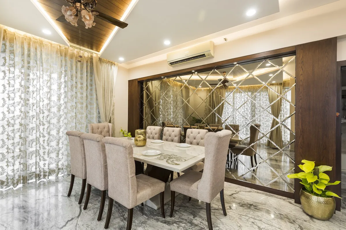 Formal dining room with a diamond-cut mirrored feature wall in a dark wood frame, marble flooring and tufted upholstered chairs around a stone-top table.