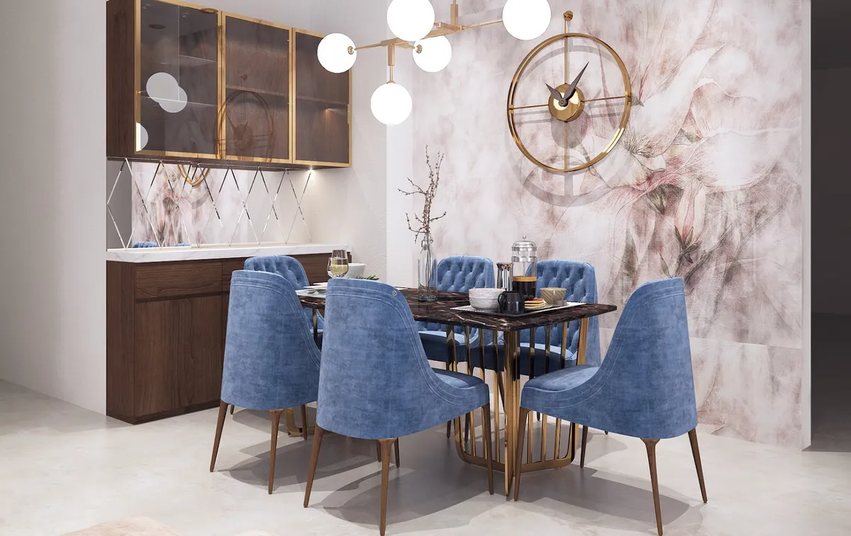 Render of a dining nook where six blue velvet chairs ring a dark marble table on a brass rod base, under a sputnik globe pendant against a blush floral mural.