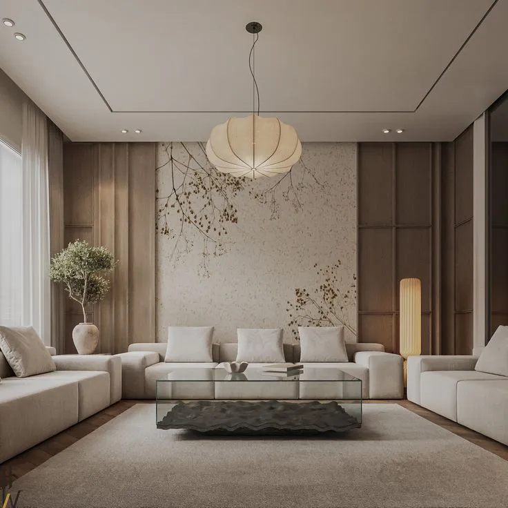 Render of a japandi living room with a botanical branch mural, wood panelled walls, a paper lantern pendant, and a sculptural glass-and-stone coffee table.