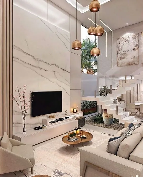 Render of a double-height living room where a full-height white marble slab wall carries the TV above a floating ivory console