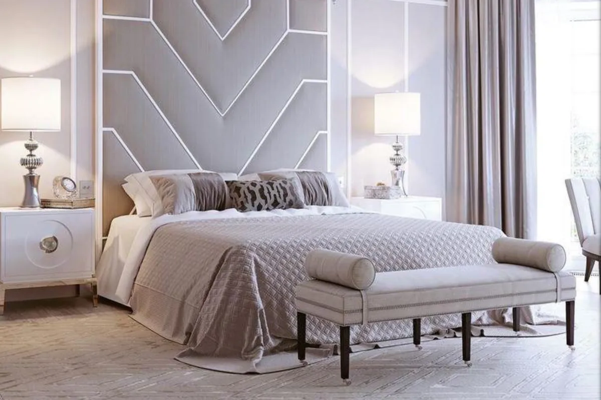 Bedroom with a two-tone chevron wall moulding headboard treatment, mirrored nightstands
