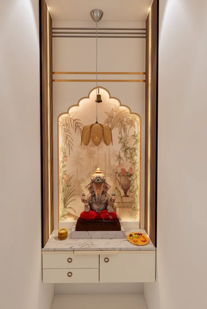 Pooja niche with a scalloped gold-trimmed arch, a botanical mural backdrop, a hanging brass bell and lotus-shaped fixture