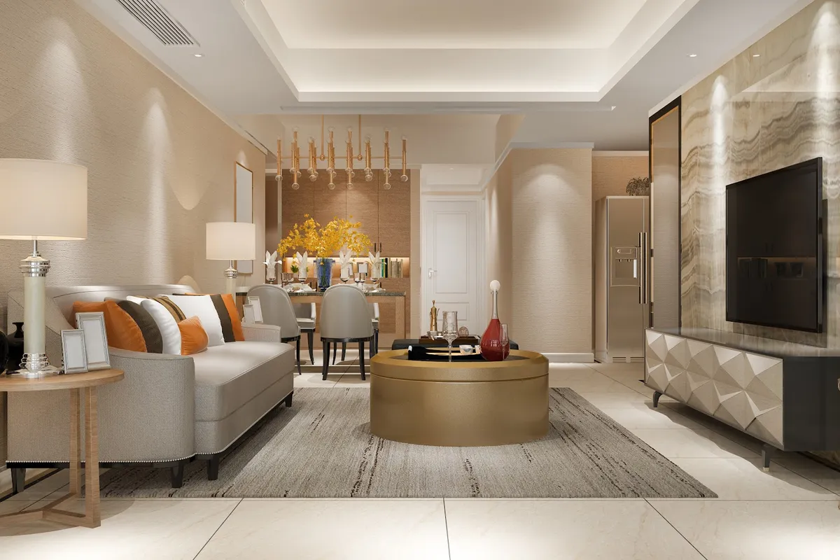 Render of a beige open living-dining where a gold drum coffee table sits on a striated grey rug facing a TV on a backlit onyx panel with a faceted white