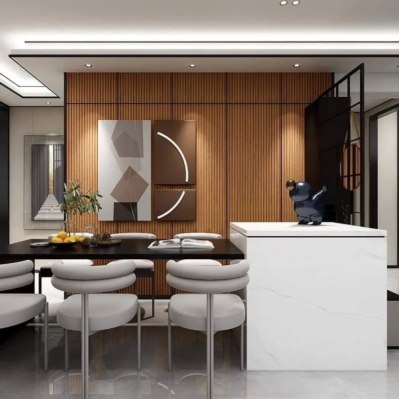 Render of a dining zone: black stone-top table with cream boucle chairs against a full-height fluted wood wall, beside a white marble waterfall island.