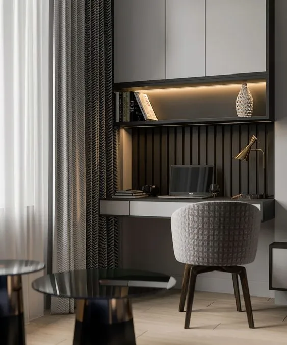 Render of a study nook with a wall-hung desk against black fluted panelling, a backlit display shelf above, and a bouclé chair by a curtained window.