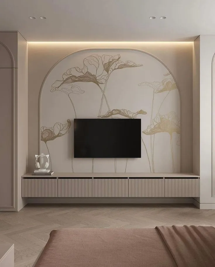 Render of a bedroom TV wall where a gold lotus line mural fills an arched niche lit from a top cove