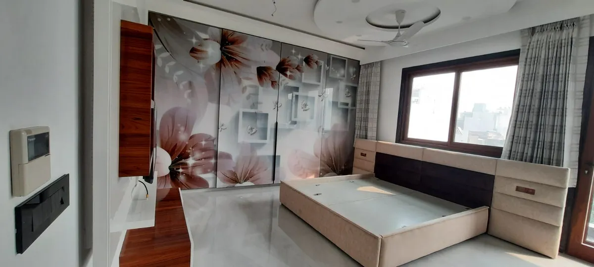 Master bedroom with a floor-to-ceiling digital-printed floral wardrobe, a wood-and-upholstered bed with integrated nightstands