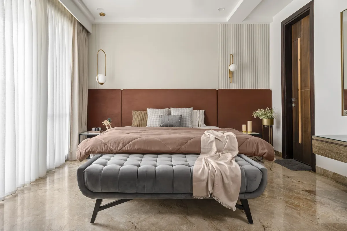 Bedroom with a terracotta channel-tufted upholstered headboard, a fluted white accent wall panel