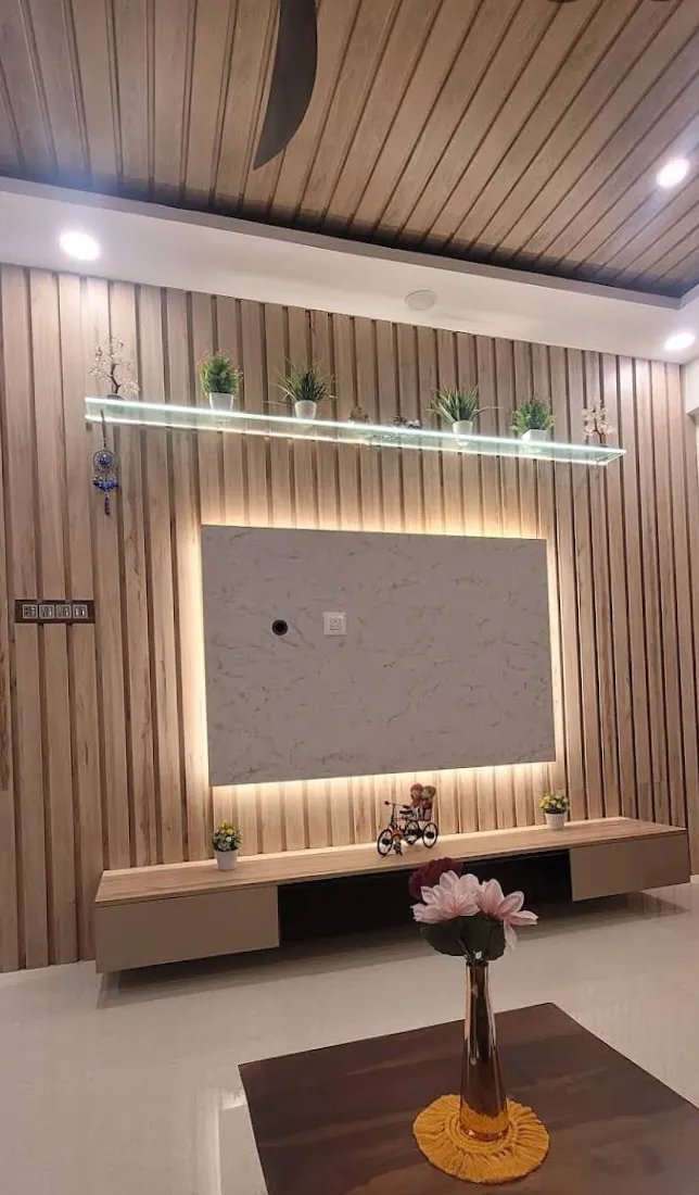 Living room feature wall of full-height oak fluted battens with a backlit white marble-look TV panel