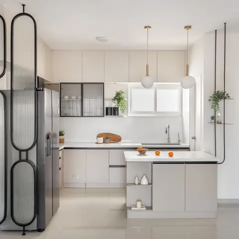 Pastel-toned modern kitchen with a fluted reeded-glass tall unit, marble-look island, and globe pendant lights opening onto