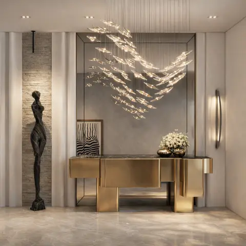 Marble-floored entrance foyer with a sculptural bird-shaped pendant light cluster above a brass geometric console table and