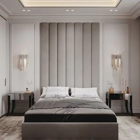 Symmetric master bedroom with a floor-to-ceiling channel-tufted headboard flanked by crystal wall sconces and mirrored